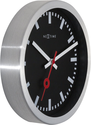 Black aluminum NeXtime Station Stripe wall or table clock with a sleek, modern design and clear time display.