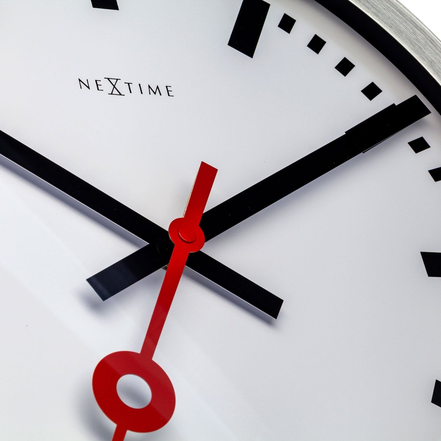 NeXtime Clocks Station Stripe aluminum wall or table clock with a modern striped design and minimalist style.