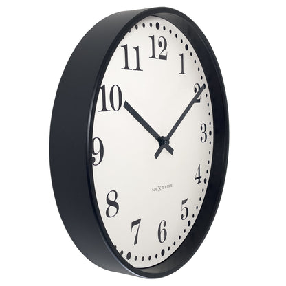 NeXtime Dickens wall clock, 30cm diameter, black and white plastic design, silent movement, shown from left side.