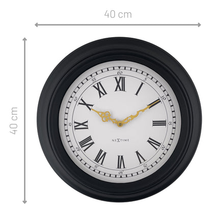 Black and grey NeXtime Chopin wall clock, 40cm with silent movement, modern plastic design, hanging on a wall.