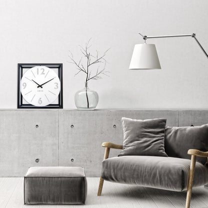 NeXtime wall clock 40x40 cm with black and white metal design, modern Time Frame style, on a plain background.
