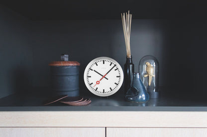 NeXtime Clocks Station Stripe aluminum wall or table clock with black hands and minimalist design.