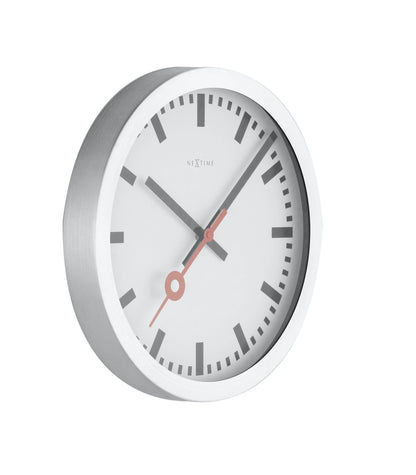 NeXtime Clocks Station Stripe aluminum wall or table clock showing a sleek, modern design with black and white striped pattern.