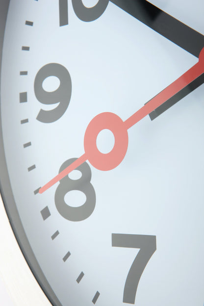 NeXtime Clocks aluminum station number wall or table clock showing a modern design with clear station number markings.