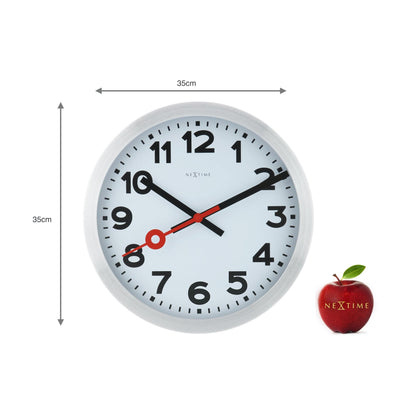 NeXtime Clocks aluminum wall or table clock with station number design, featuring a modern, minimalist style.