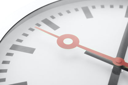 NeXtime Clocks Station Stripe aluminum wall or table clock with a sleek, modern design and striped pattern.