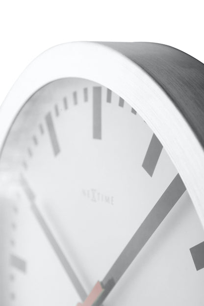 NeXtime Clocks Station Stripe aluminum wall or table clock with a sleek, modern design and striped pattern.