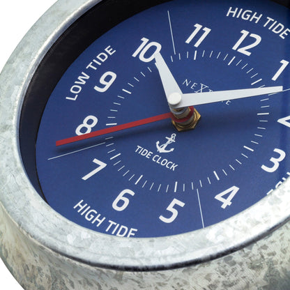 NeXtime Tide wall clock with galvanized silver finish, 22cm diameter, displaying tide status and time in a sleek design.