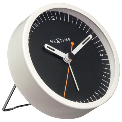 NeXtime small metal table alarm clock with light function, silent operation, 9x9x7.5cm, shown from left side.