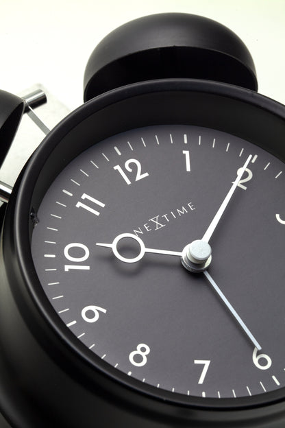 NeXtime Golden Hour alarm clock with metal frame, 12x14x6cm, showcasing its stylish design and metallic finish.