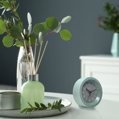 NeXtime Circle alarm clock with silent light dial, measuring 10.5cm x 3.6cm, stylish table clock with modern design.