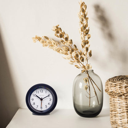 NeXtime Circle alarm clock with light dial, silent operation, 10.5cm diameter, and modern design.