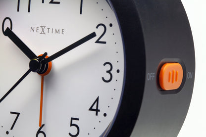 NeXtime Circle alarm clock with silent light dial, 10.5cm x 3.6cm, featuring a modern round design and clear clock face.