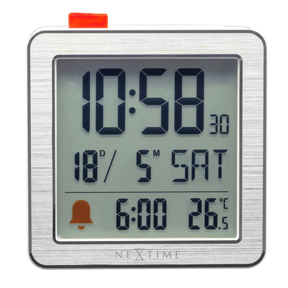 NeXtime Mini digital table alarm clock with metal and ABS case, compact 6x6.4x2.1cm, displaying time on a digital screen.