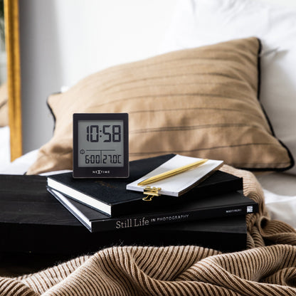 NeXtime digital table alarm clock with LED display, compact size, black color, and "Wake Up" feature.