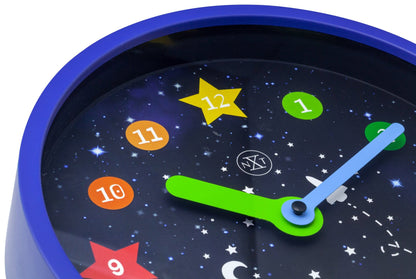 NeXtime Apollo wall clock, 26 cm plastic design with black hour and minute hands, clear dial, and minimalistic style.